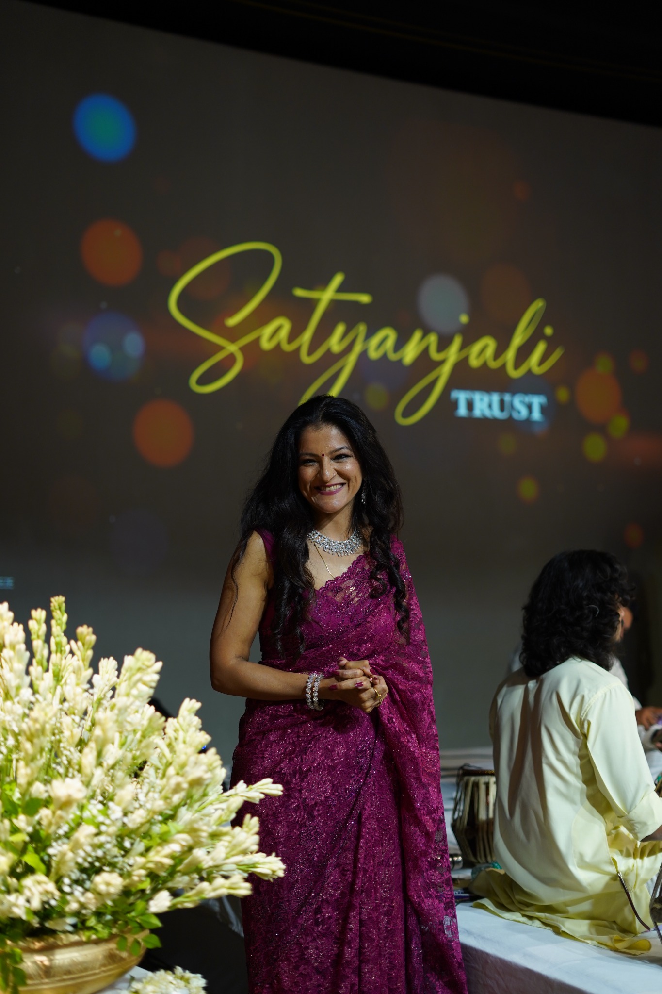 Meghna smiling on stage